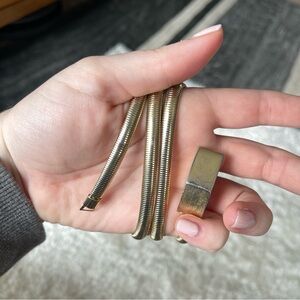 Vintage 1980s thin dainty stretch belt gold, made of metal with clasp!